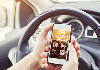 car insurance concept, driver reading website on smartphone